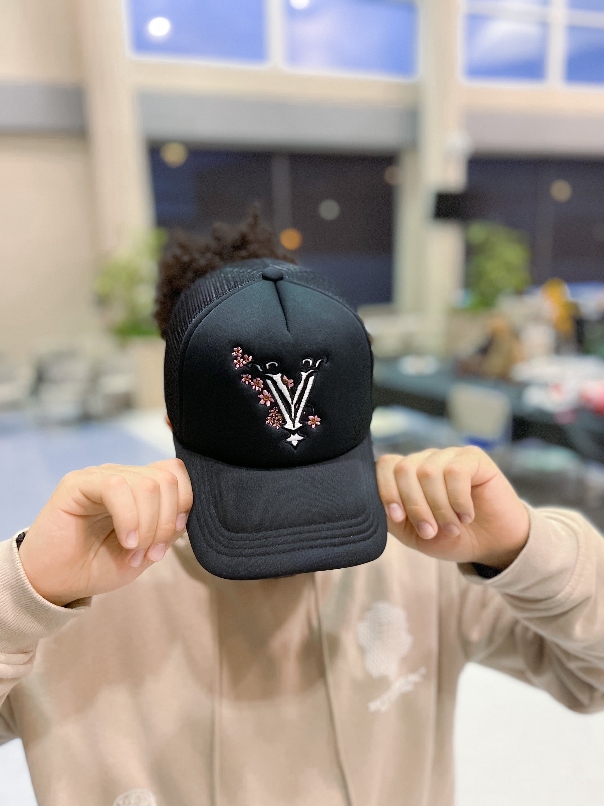 Black designer trucker hat with embroidery logo